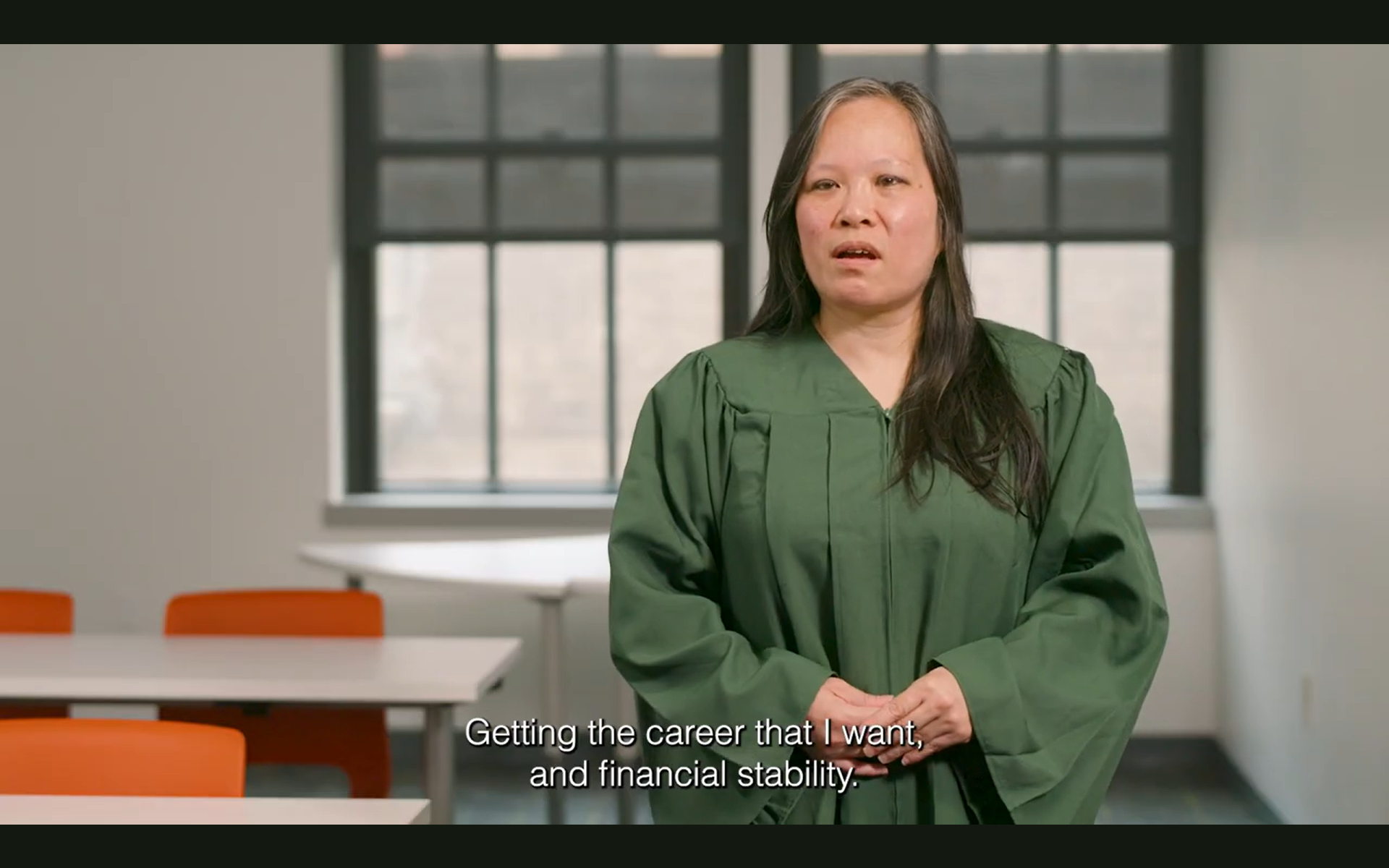 Screenshot from Video of excel center graduate in cap and gown