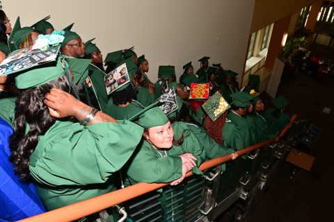 100th graduate waits in line with the excel center graduates.