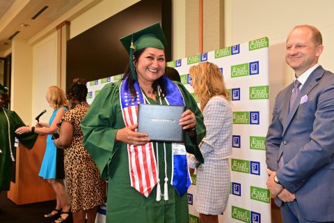 Graduate smiling with her diploma
