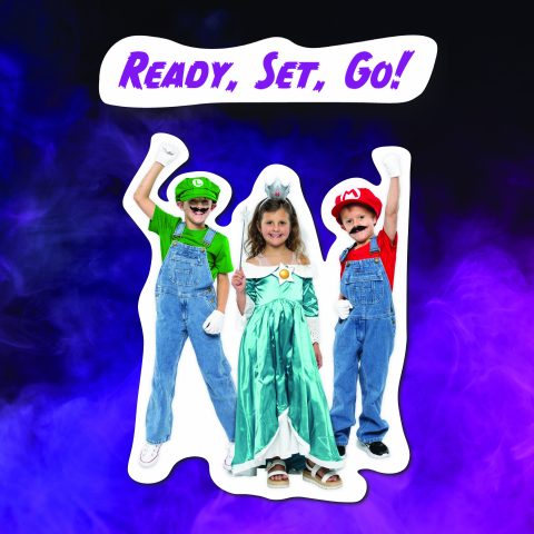Three children wearing thrifted DIY costumes dressed as Mario, Luigi, and Rosalina from the Nintendo video game and media series Super Mario Bros.